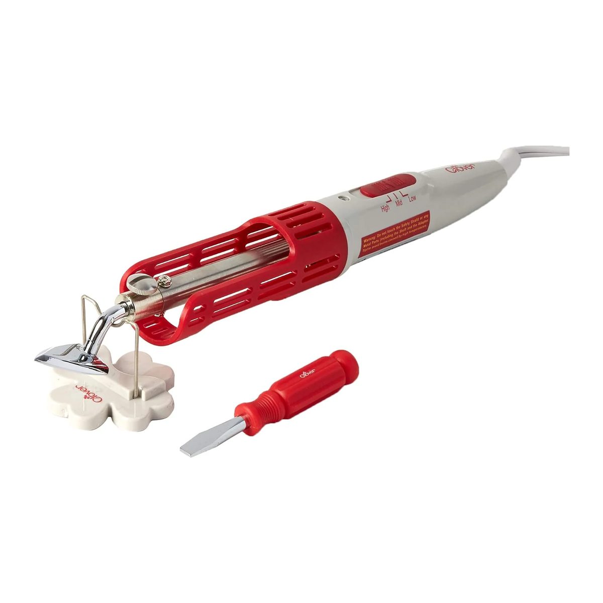 Mini plancha Clover Mini Iron II apoyada en su soporte en forma de trébol, junto al destornillador para cambiar la punta